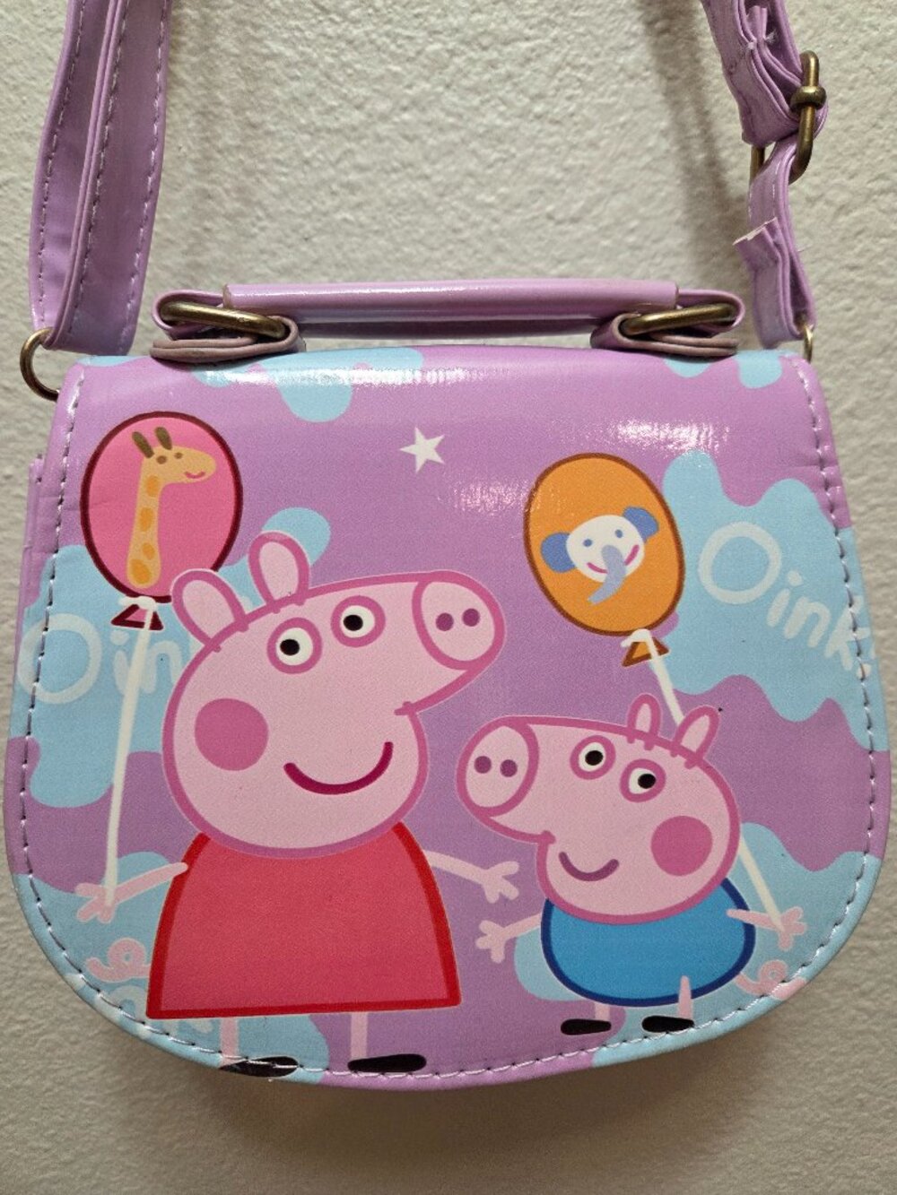 Peppa Pig kids crossbody purse and handbag.It features a light purple/lavender